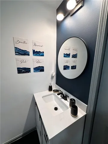 a bathroom with a sink mirror and vanity