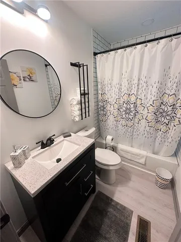 a bathroom with a sink toilet and shower