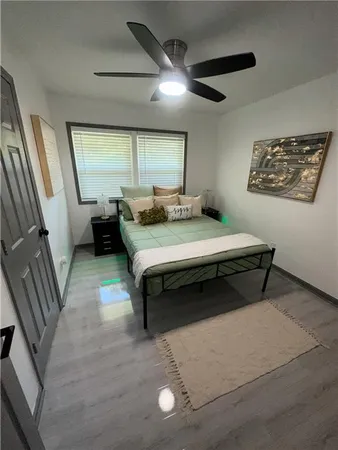 a bedroom with a bed and a large mirror