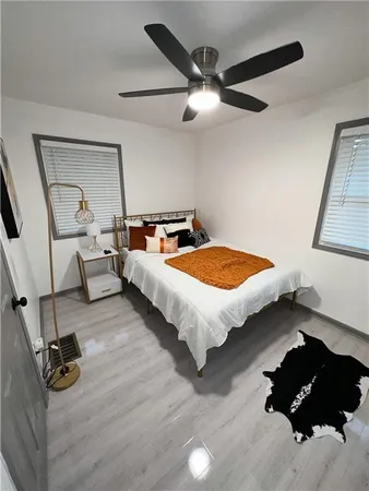 a bedroom with bed window and couch