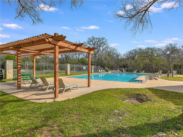 a view of a backyard with a swimming pool