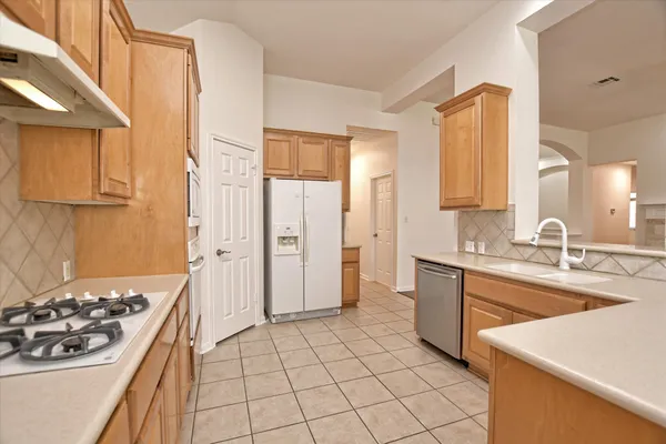 a kitchen with a sink stove and refrigerator