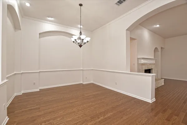a view of a room with wooden floor and white walls