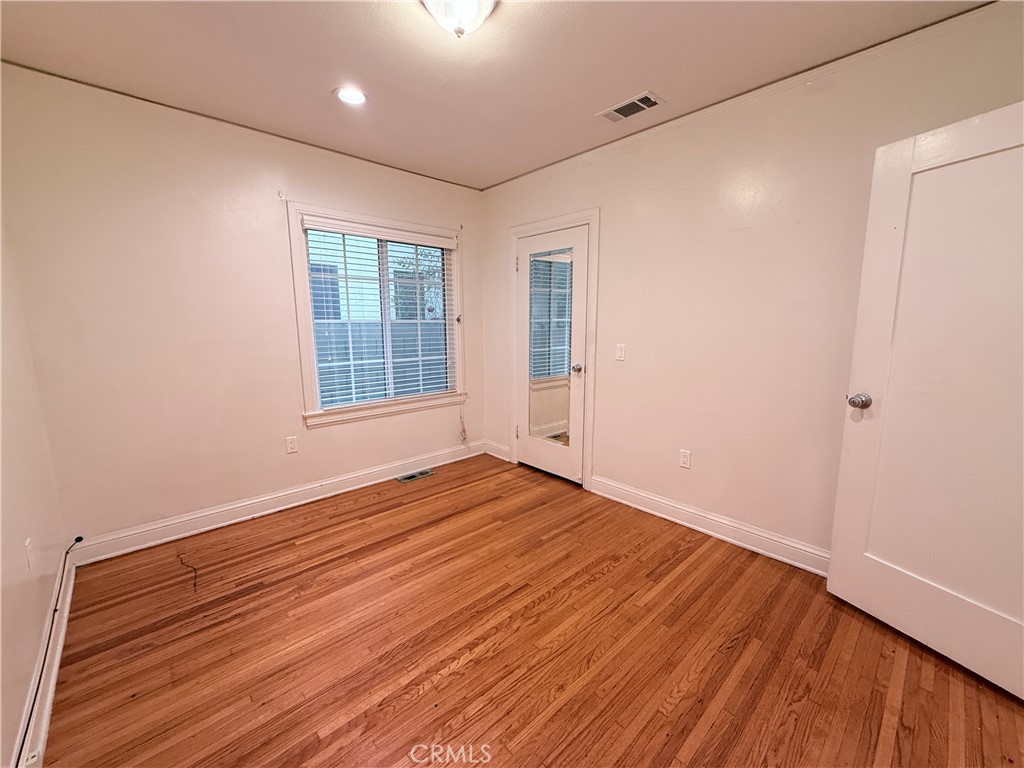 1837 South 7th Street Alhambra, CA 91803 - Photo 11 of 17 a view of an empty room with wooden floor and a window