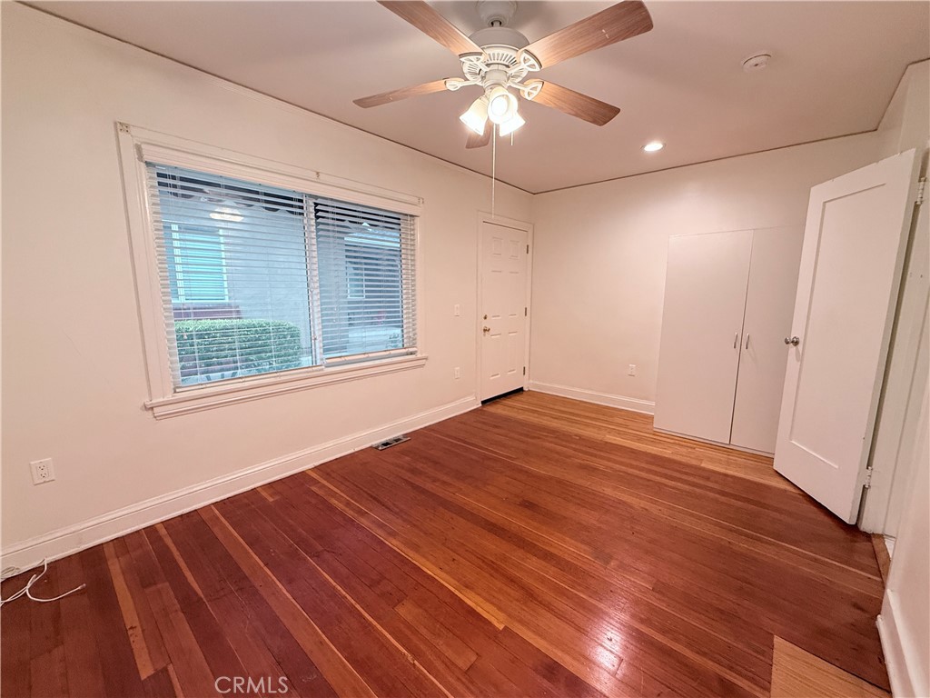 1837 South 7th Street Alhambra, CA 91803 - Photo 13 of 17 an empty room with wooden floor chandelier fan and windows