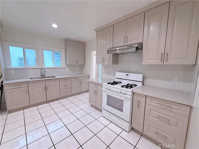 a kitchen with cabinets appliances and a sink