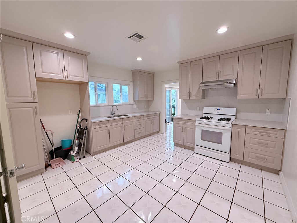 1837 South 7th Street Alhambra, CA 91803 - Photo 7 of 17 a kitchen with cabinets and white appliances