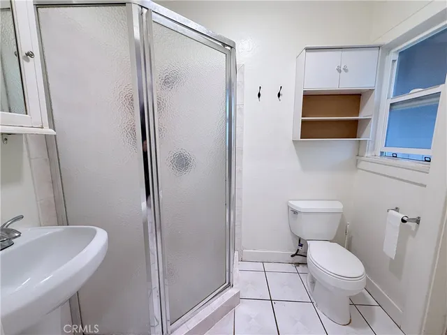 a bathroom with a toilet a sink and a shower