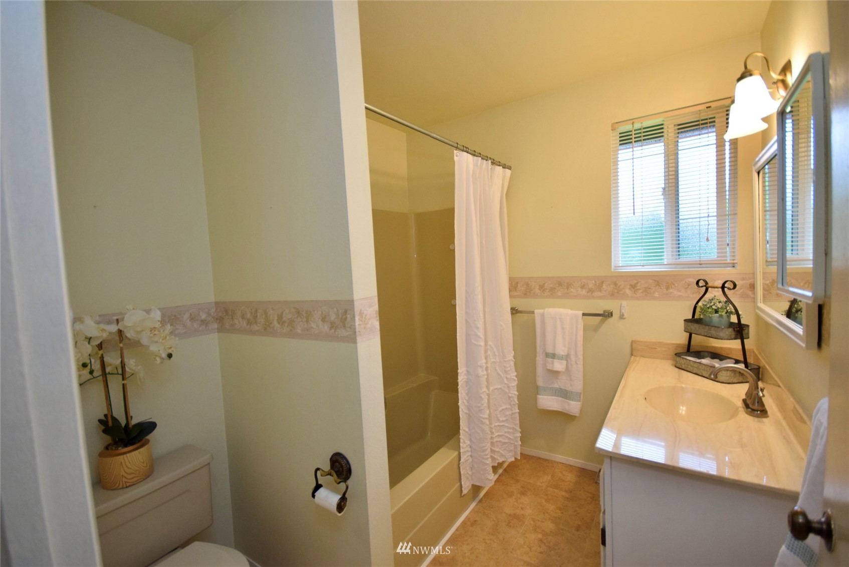 21 Clary Lane Sequim, WA 98382 - Photo 17 of 29 a bathroom with a sink a toilet a mirror and shower