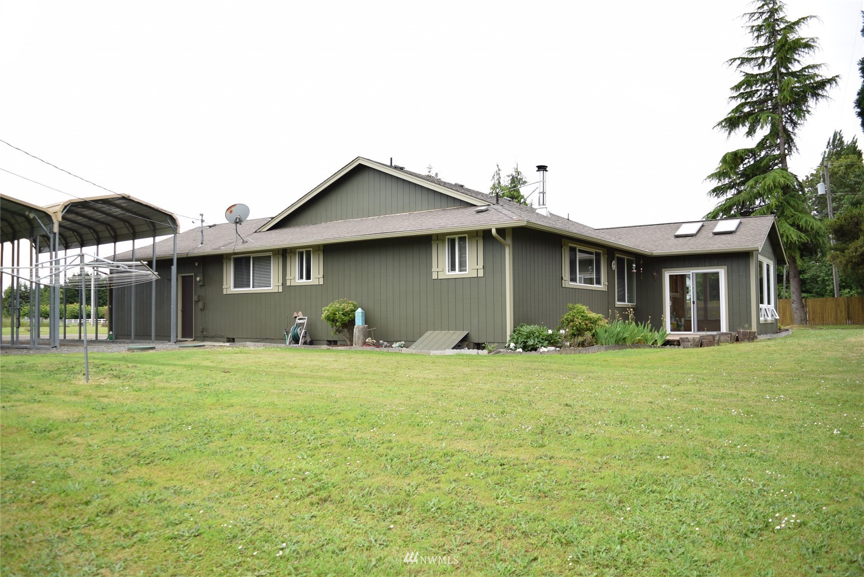 21 Clary Lane Sequim, WA 98382 - Photo 28 of 29 a front view of a house with a garden