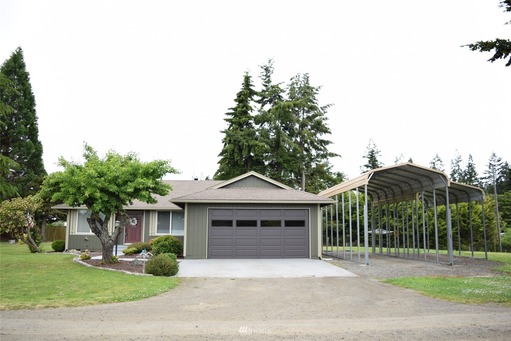 21 Clary Lane Sequim, WA 98382 - Photo 3 of 29 a front view of a house with a garden and plants