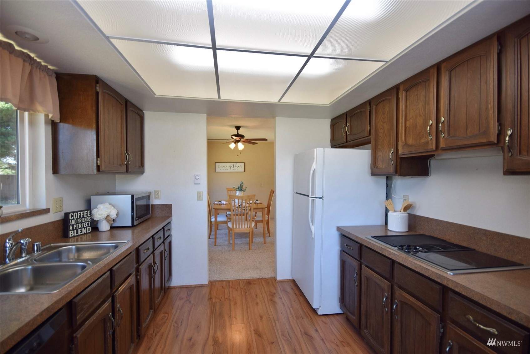 21 Clary Lane Sequim, WA 98382 - Photo 10 of 29 a kitchen with stainless steel appliances granite countertop wooden cabinets stove top oven and sink