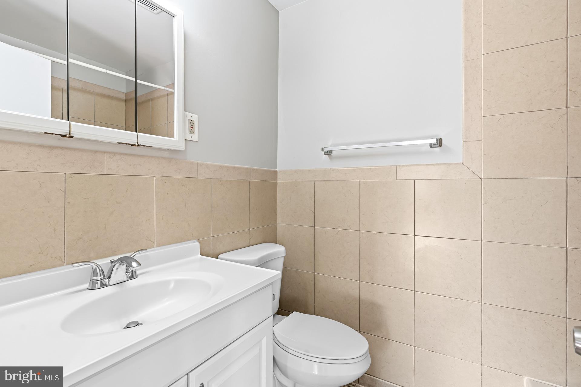 7616 Savannah Street, Unit 201 Falls Church, VA 22043 - Photo 15 of 29 a bathroom with a sink a toilet and shower