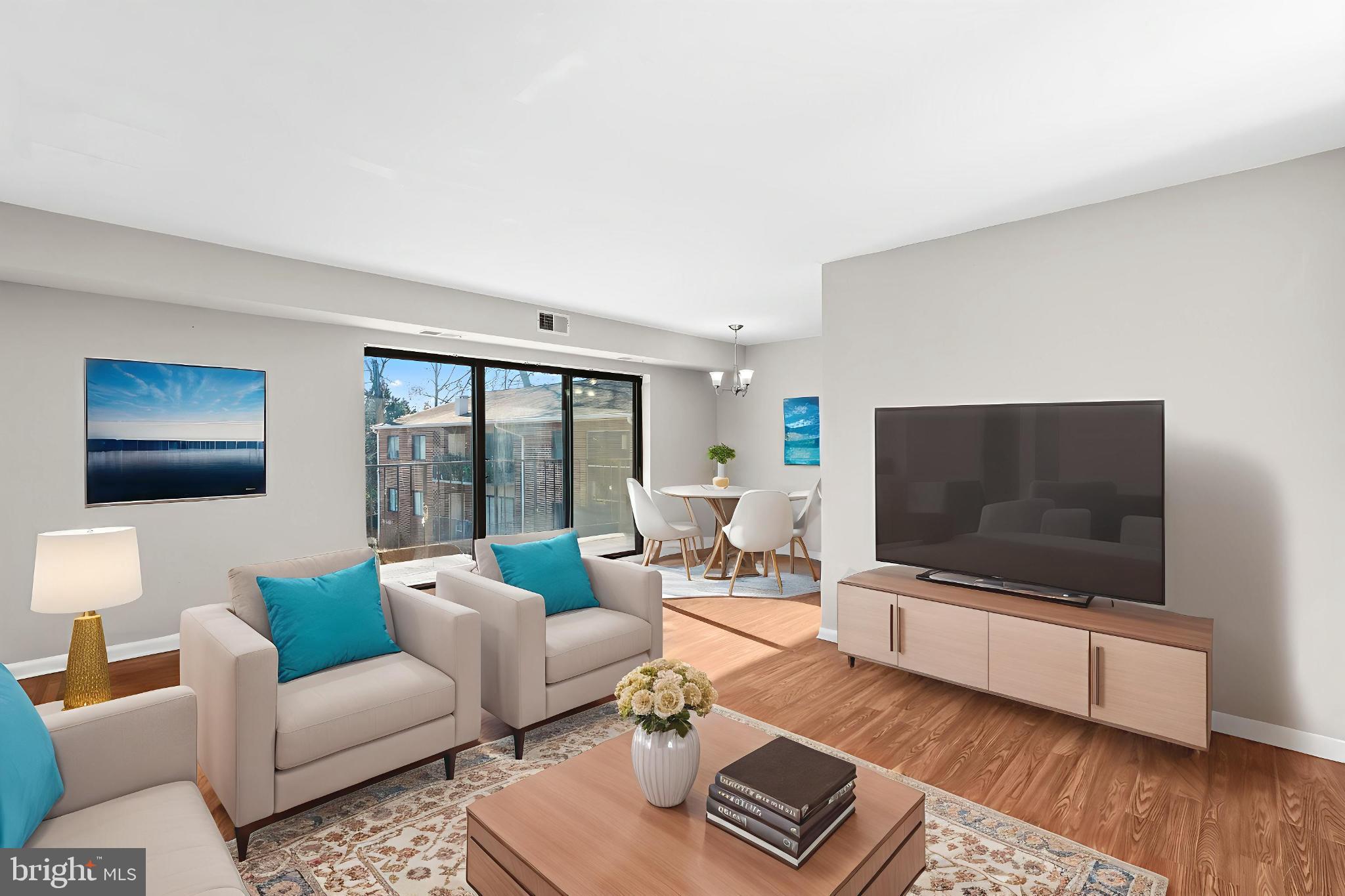 7616 Savannah Street, Unit 201 Falls Church, VA 22043 - Photo 2 of 29 a living room with furniture and a flat screen tv