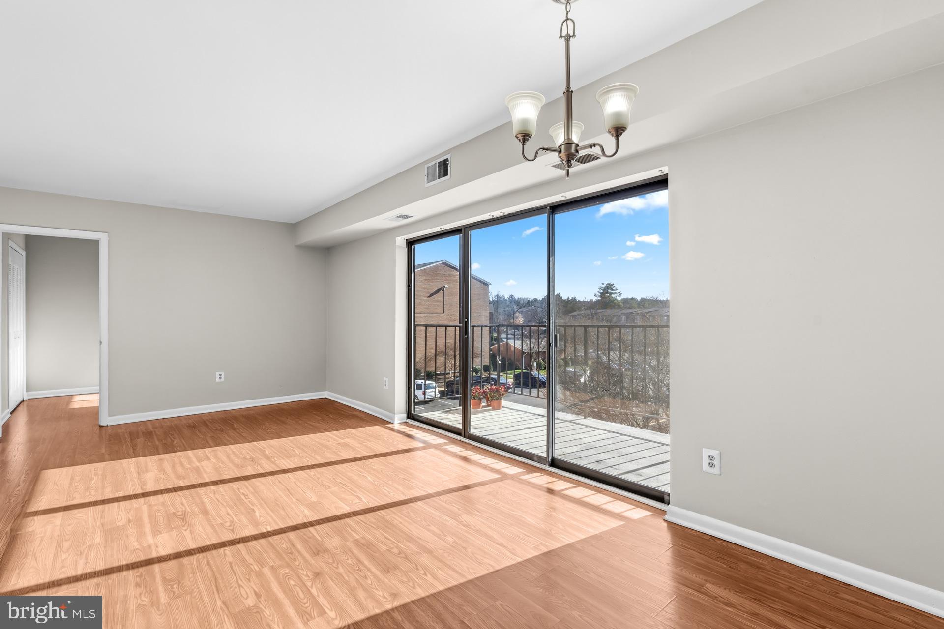 7616 Savannah Street, Unit 201 Falls Church, VA 22043 - Photo 3 of 29 a bedroom with a large bed and a chandelier