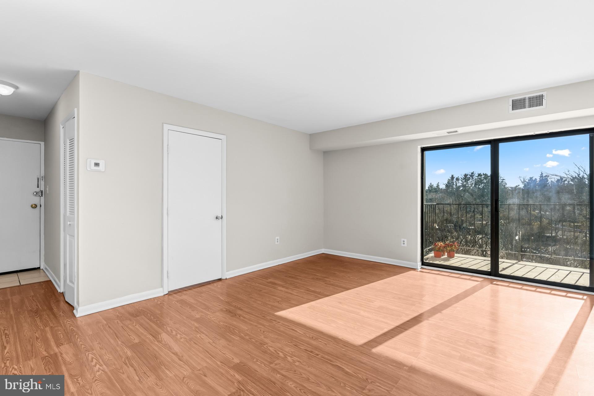 7616 Savannah Street, Unit 201 Falls Church, VA 22043 - Photo 8 of 29 an empty room with wooden floor and windows