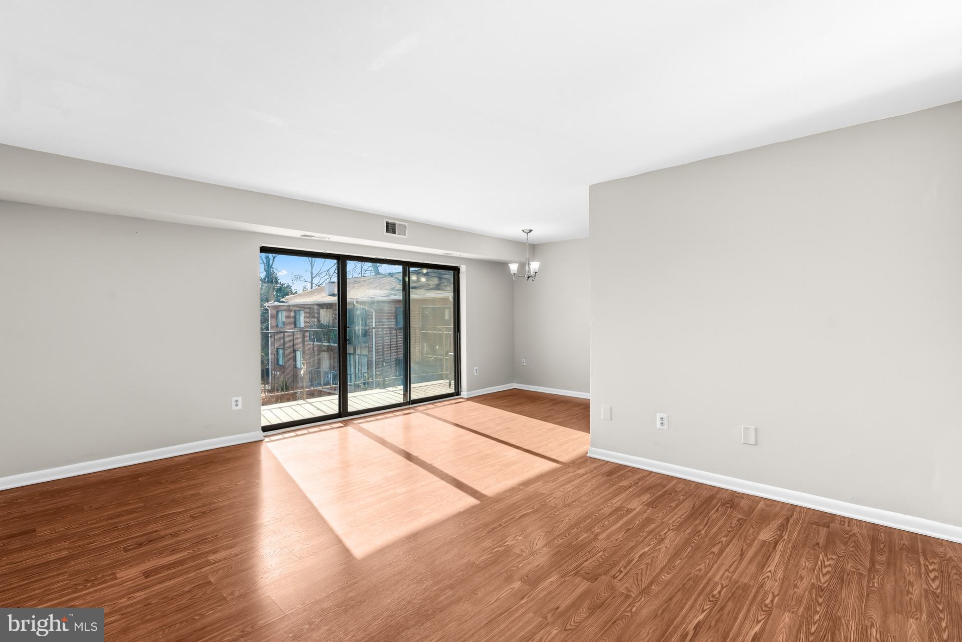 7616 Savannah Street, Unit 201 Falls Church, VA 22043 - Photo 9 of 29 a view of an empty room with glass door
