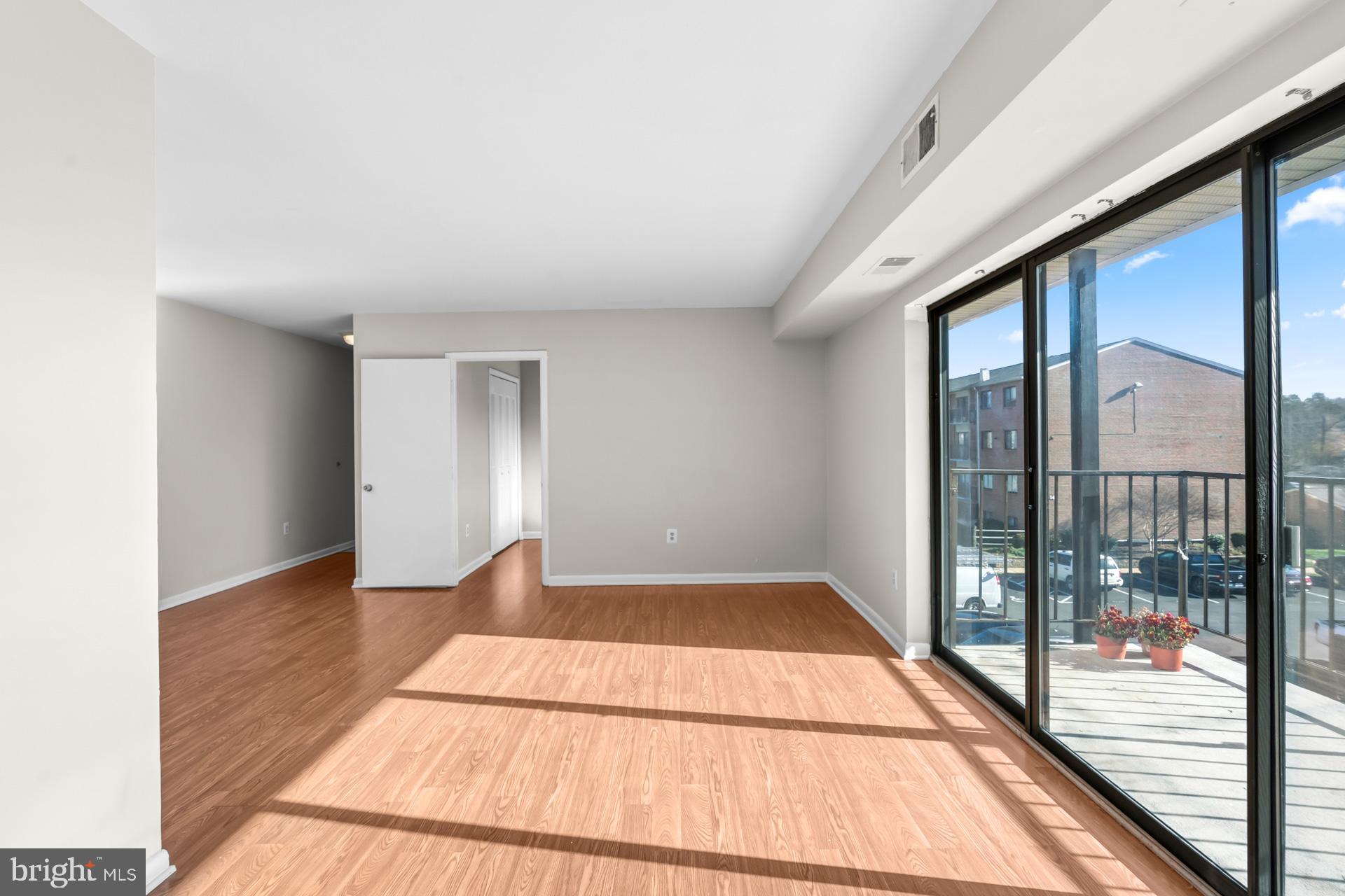 7616 Savannah Street, Unit 201 Falls Church, VA 22043 - Photo 10 of 29 a view of empty room with wooden floor and fan