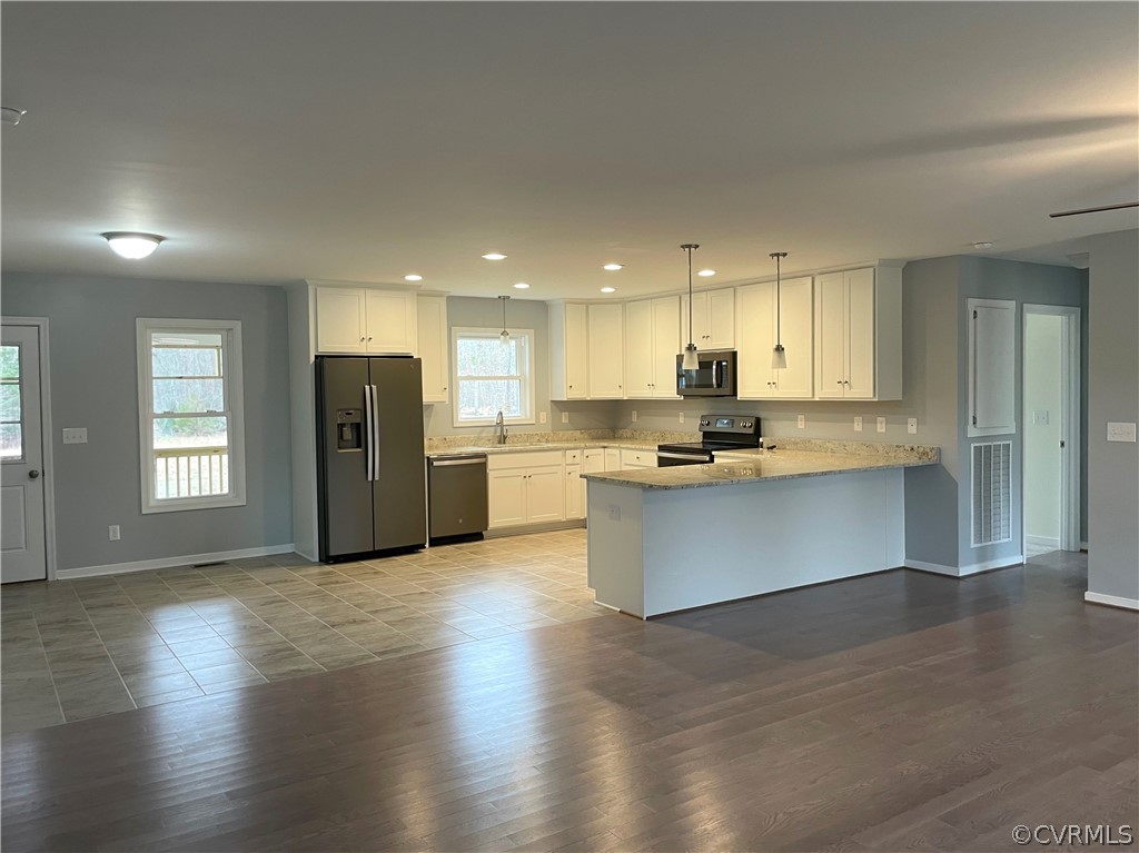 206 Wilson Road Blackstone, VA 23824 - Photo 11 of 38 a kitchen with stainless steel appliances granite countertop a stove a refrigerator a sink and a microwave