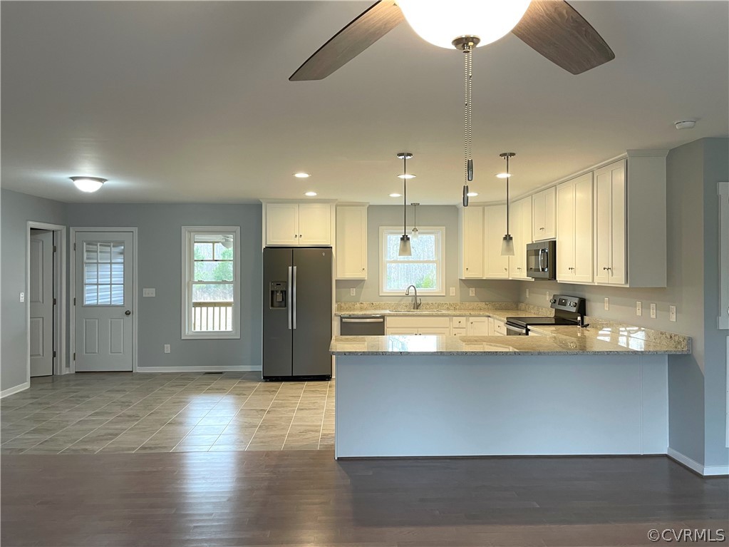 206 Wilson Road Blackstone, VA 23824 - Photo 12 of 38 a large kitchen with stainless steel appliances granite countertop a sink a stove and a refrigerator