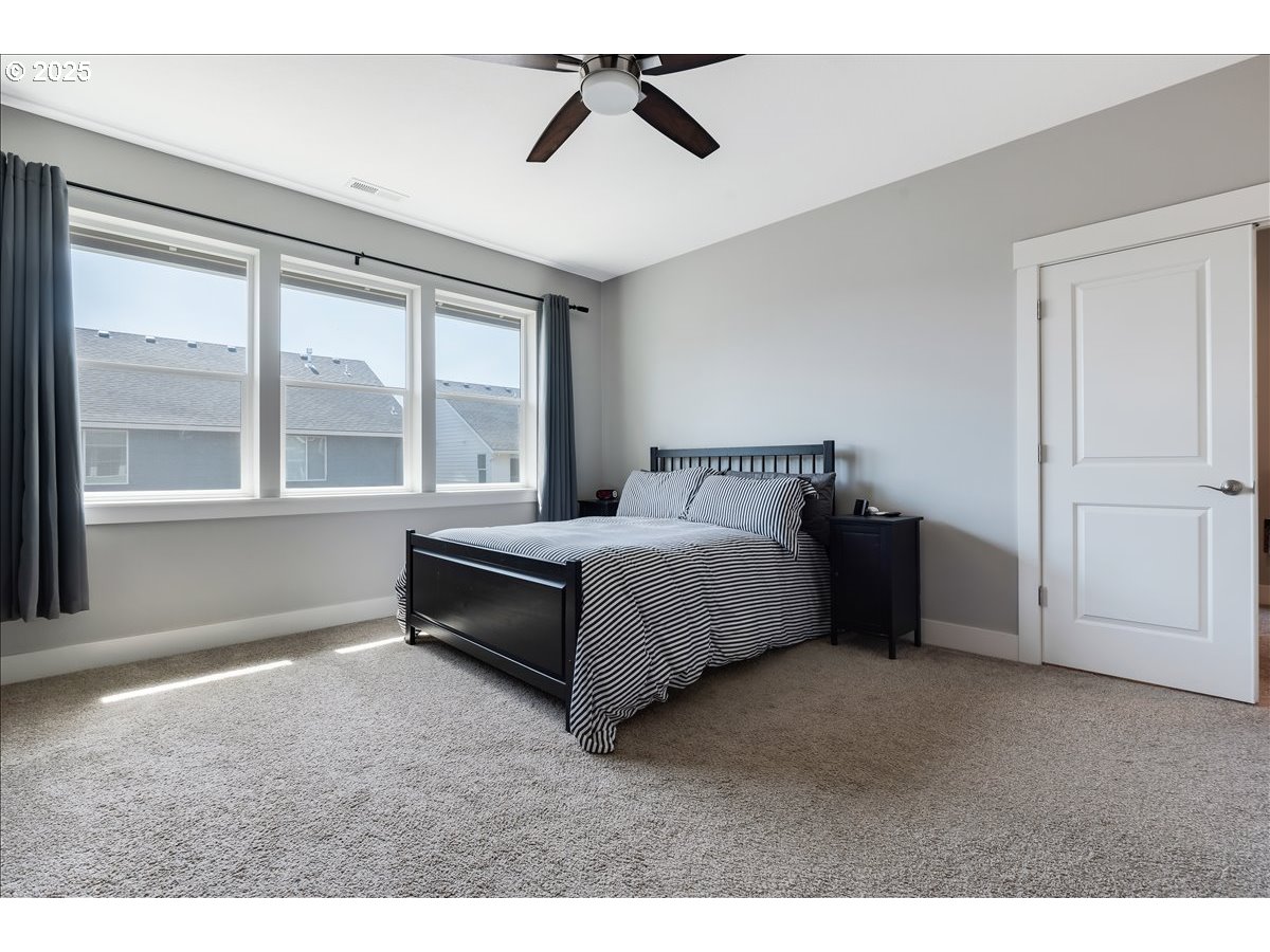 2754 Inna Avenue Northwest Salem, OR 97304 - Photo 20 of 34 a bedroom with a bed and a large window