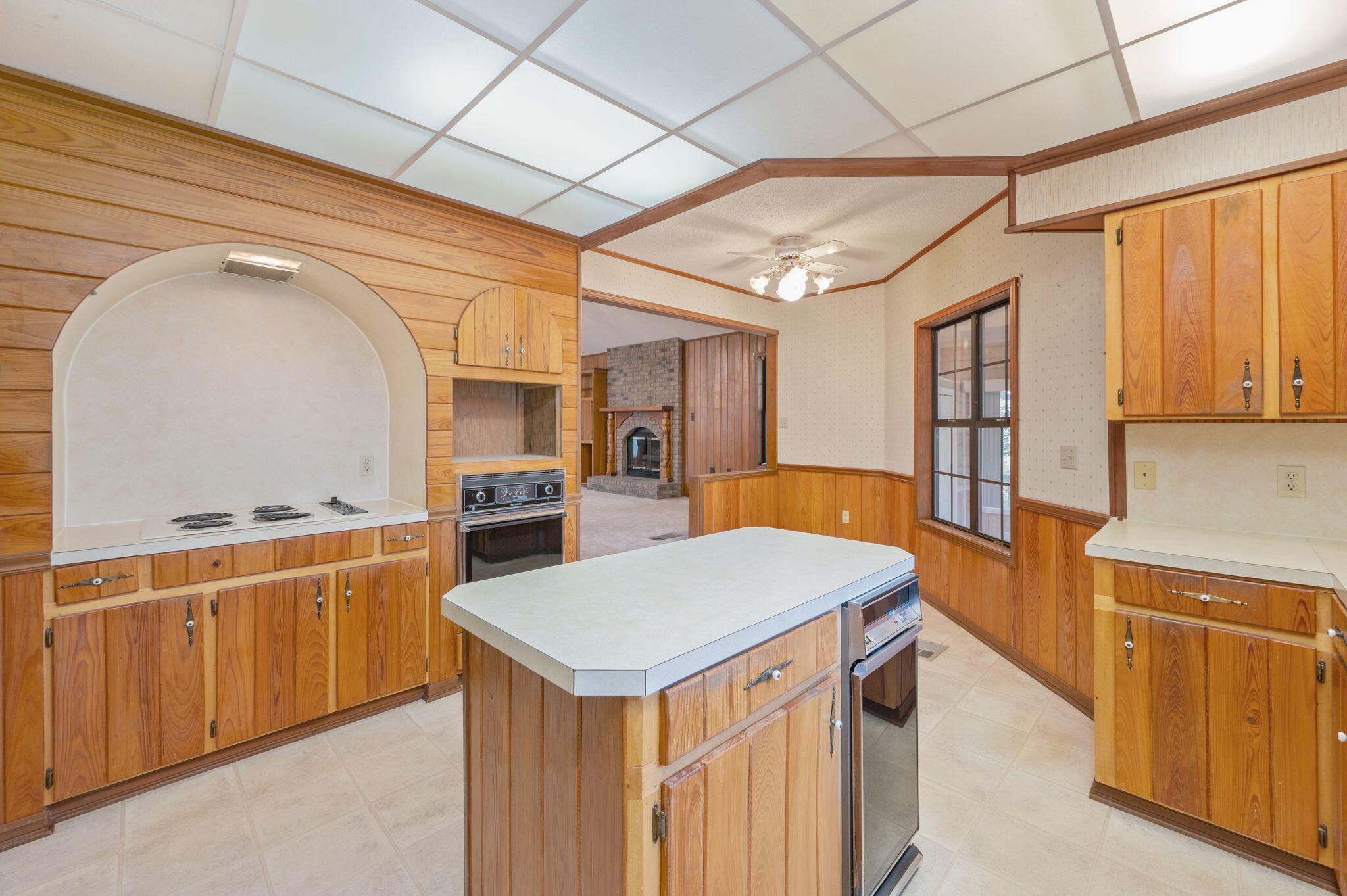 5644 Old Bethel Road Crestview, FL 32536 - Photo 14 of 55 a kitchen that has a lot of cabinets in it and wooden floor