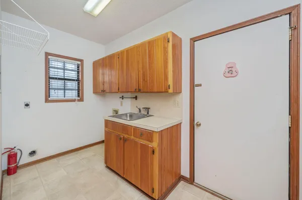 a white bath tub sitting next to a white wooden tub