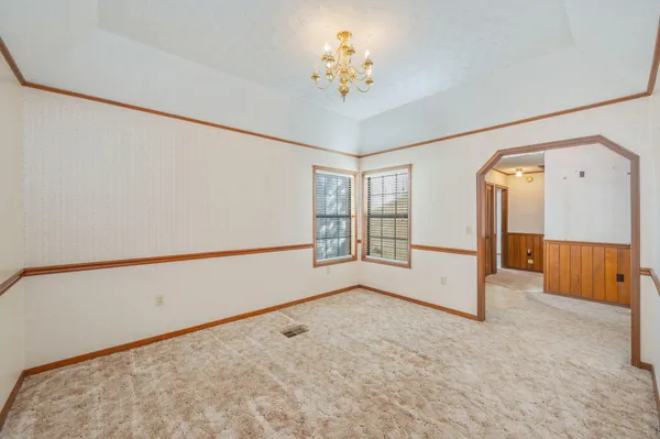 a view of a hallway with wooden floor and entryway