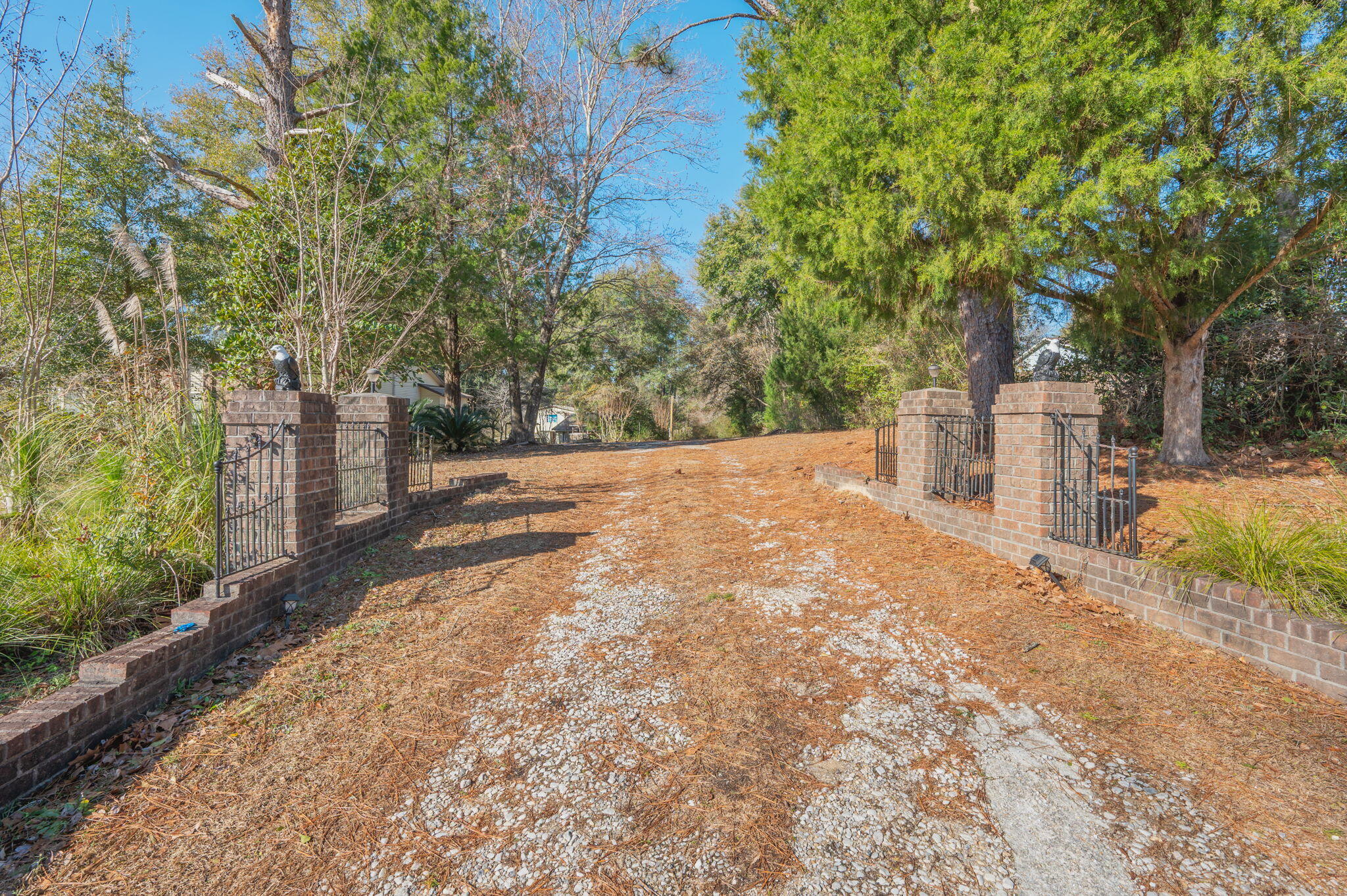 5644 Old Bethel Road Crestview, FL 32536 - Photo 2 of 55 a backyard of a house with large trees and outdoor seating