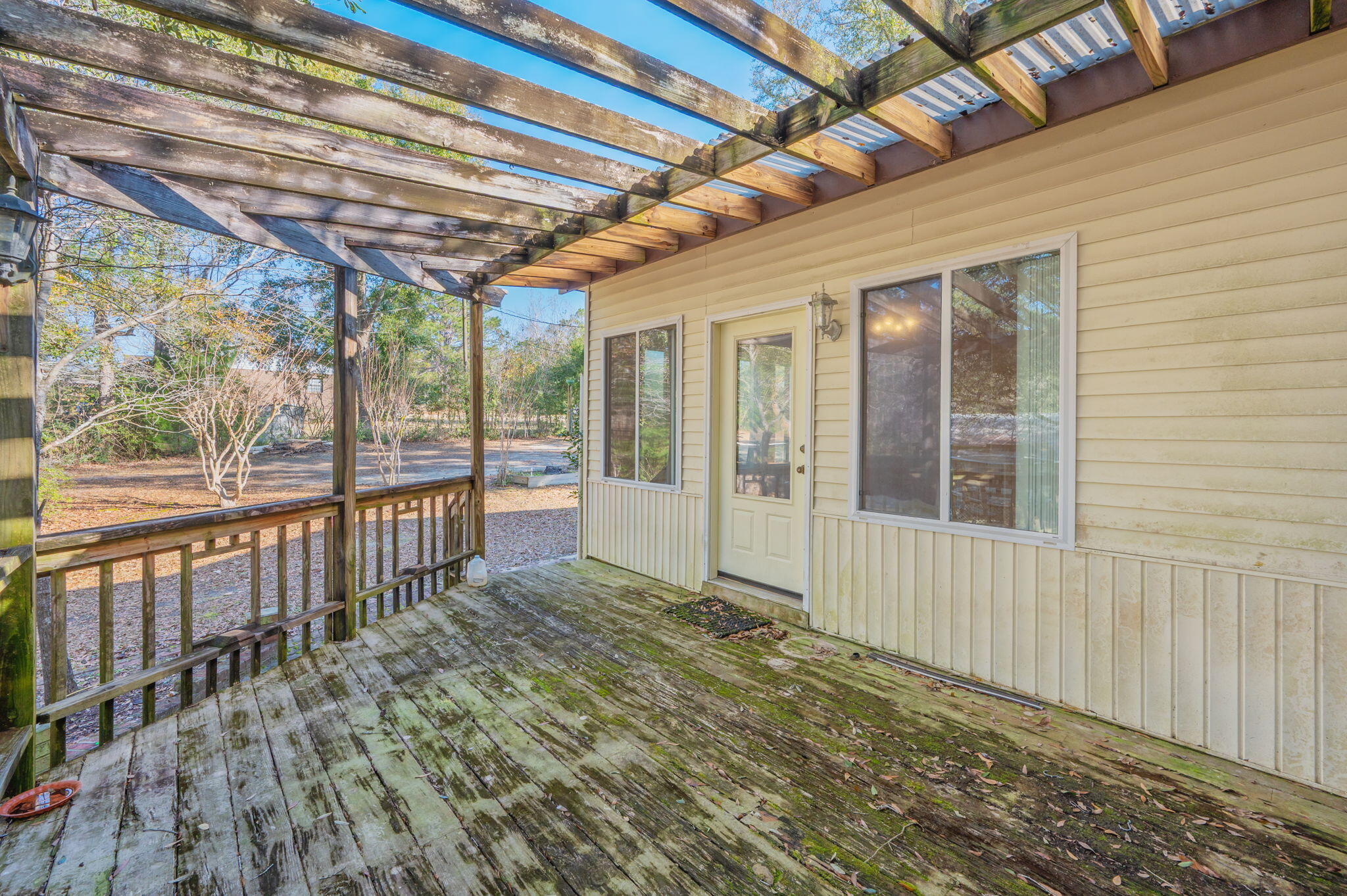 5644 Old Bethel Road Crestview, FL 32536 - Photo 43 of 55 a porch with a table and chairs next to a window