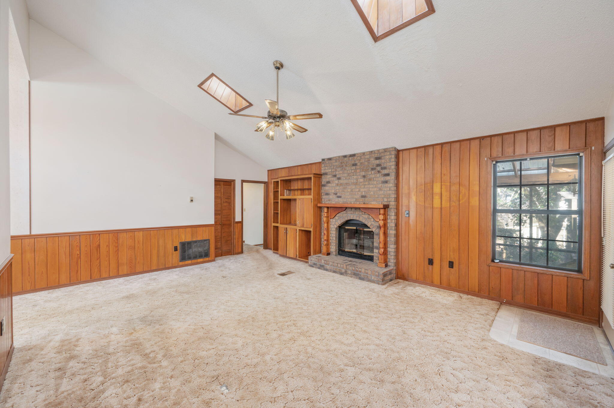 5644 Old Bethel Road Crestview, FL 32536 - Photo 8 of 55 an empty room with fireplace fan and windows