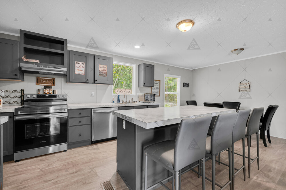 107 Clearwater Shores Road Fair Play, SC 29643 - Photo 8 of 23 An expansive kitchen island anchors this modern culinary space featuring vinyl plank flooring.