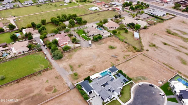 an aerial view of a house with a yard and lake view