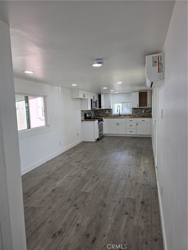 12401 Filmore Street, Unit 637 Sylmar, CA 91342 - Photo 2 of 14 a large kitchen with a large counter top appliances and cabinets