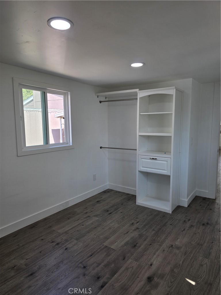 12401 Filmore Street, Unit 637 Sylmar, CA 91342 - Photo 6 of 14 a view of an empty room with a window and wooden floor