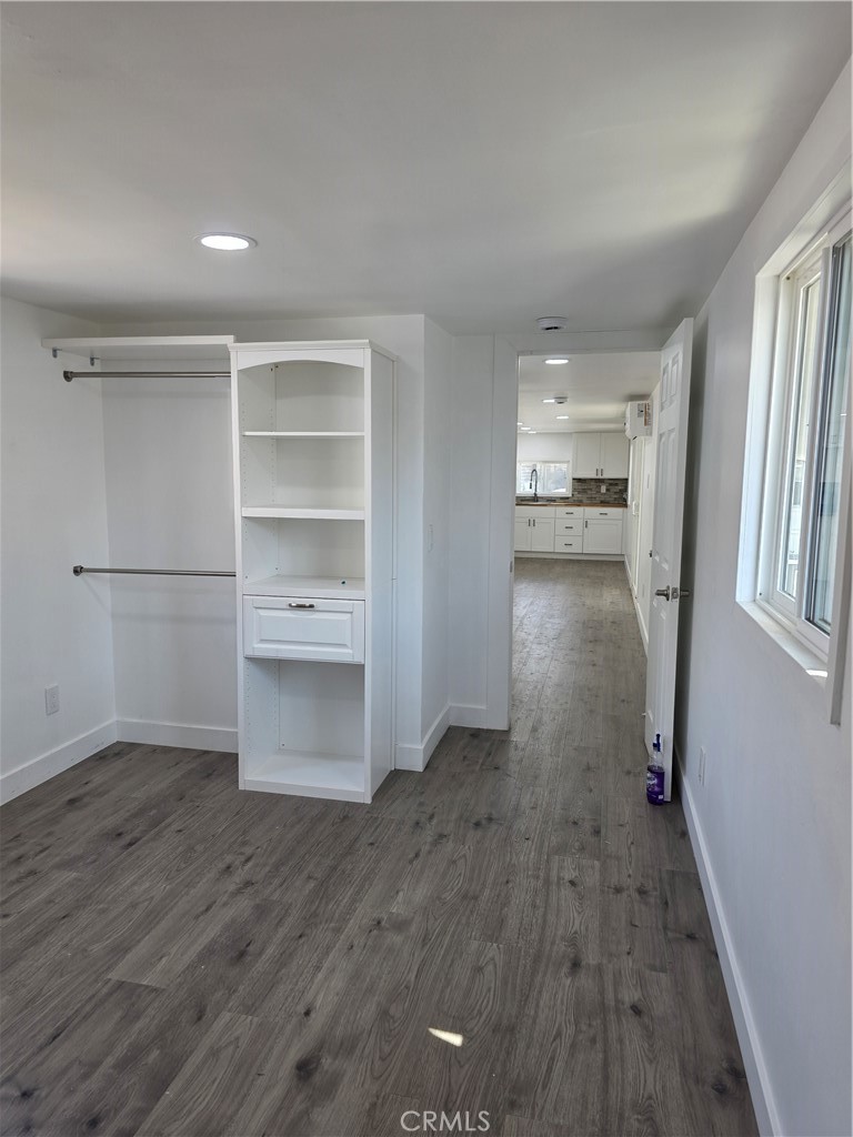 12401 Filmore Street, Unit 637 Sylmar, CA 91342 - Photo 7 of 14 a view of empty room with wooden floor and cabinet