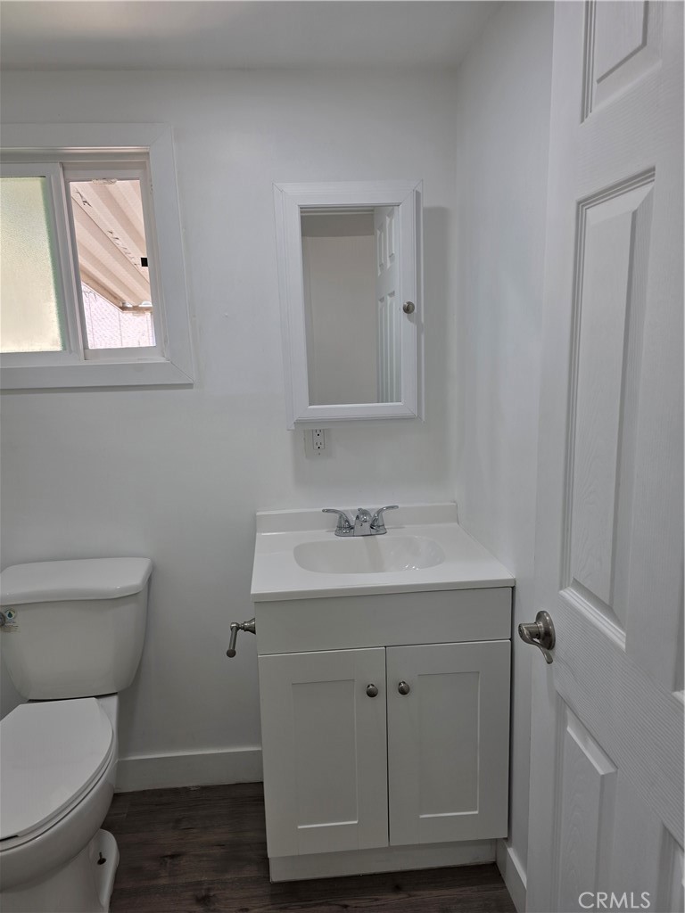 12401 Filmore Street, Unit 637 Sylmar, CA 91342 - Photo 10 of 14 a bathroom with a toilet a sink and mirror