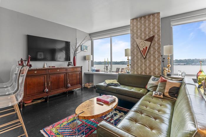 200 Riverside Boulevard, Unit 5L Manhattan, NY 10069 - Photo 1 of 13 a living room with furniture and a flat screen tv