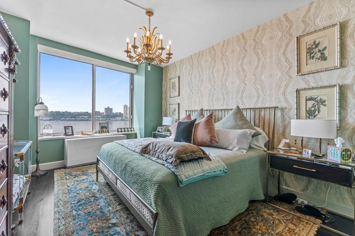 200 Riverside Boulevard, Unit 5L Manhattan, NY 10069 - Photo 5 of 13 a bed room with furniture and a chandelier