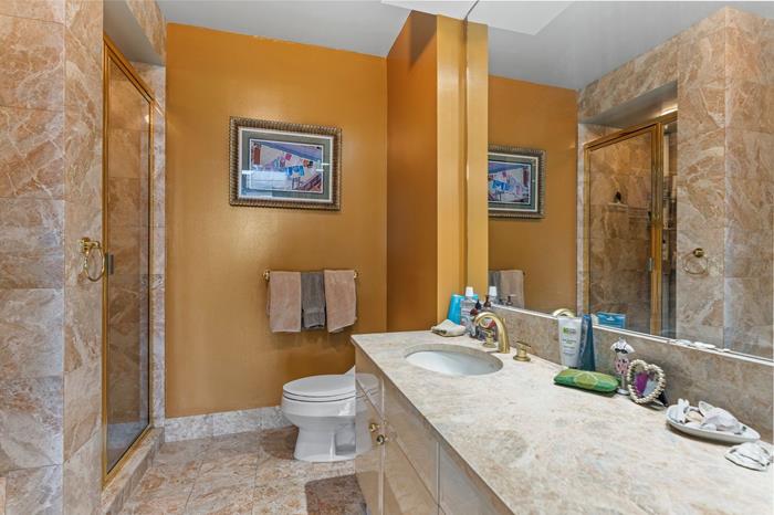 200 Riverside Boulevard, Unit 5L Manhattan, NY 10069 - Photo 6 of 13 a bathroom with a granite countertop sink mirror vanity and toilet