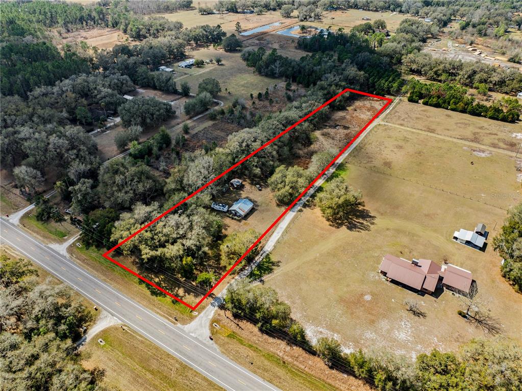 14258 State Rte 471 Webster, FL 33597 - Photo 1 of 1 an aerial view of a house with a yard and lake view