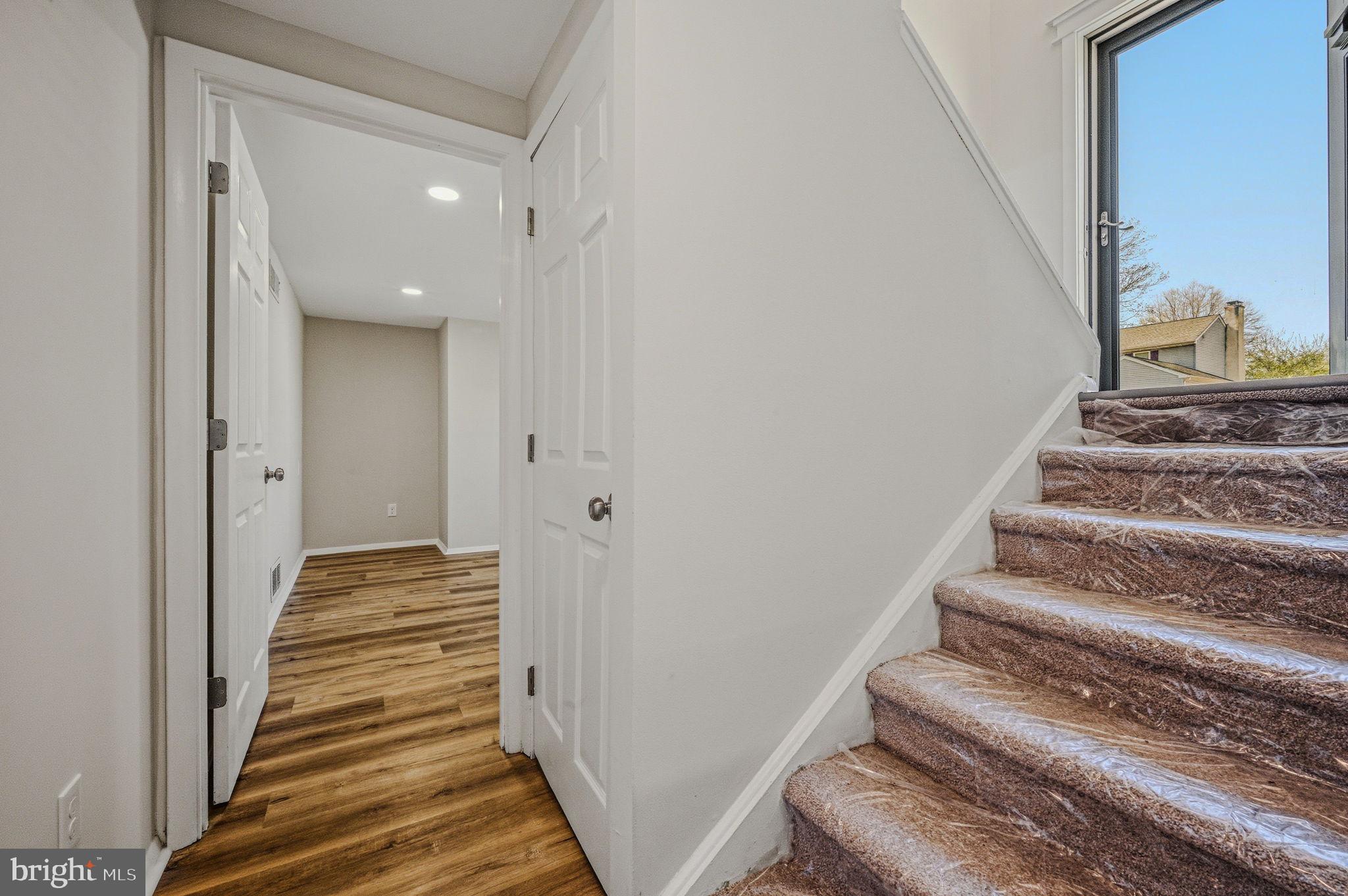 106 Fox Drive Newark, DE 19713 - Photo 24 of 37 a view of a hallway with wooden floor and staircase