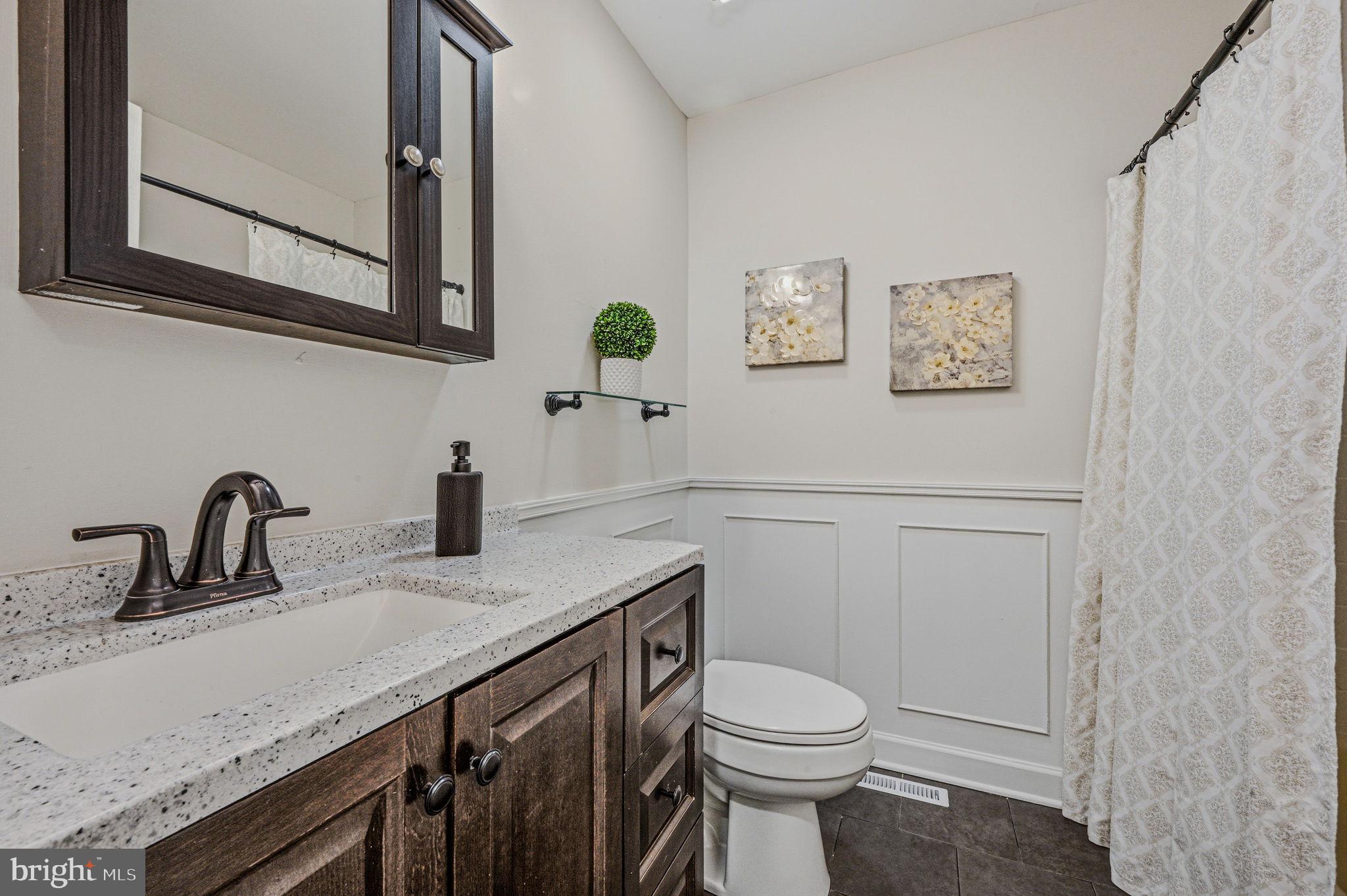 106 Fox Drive Newark, DE 19713 - Photo 29 of 37 a bathroom with a granite countertop toilet sink and mirror