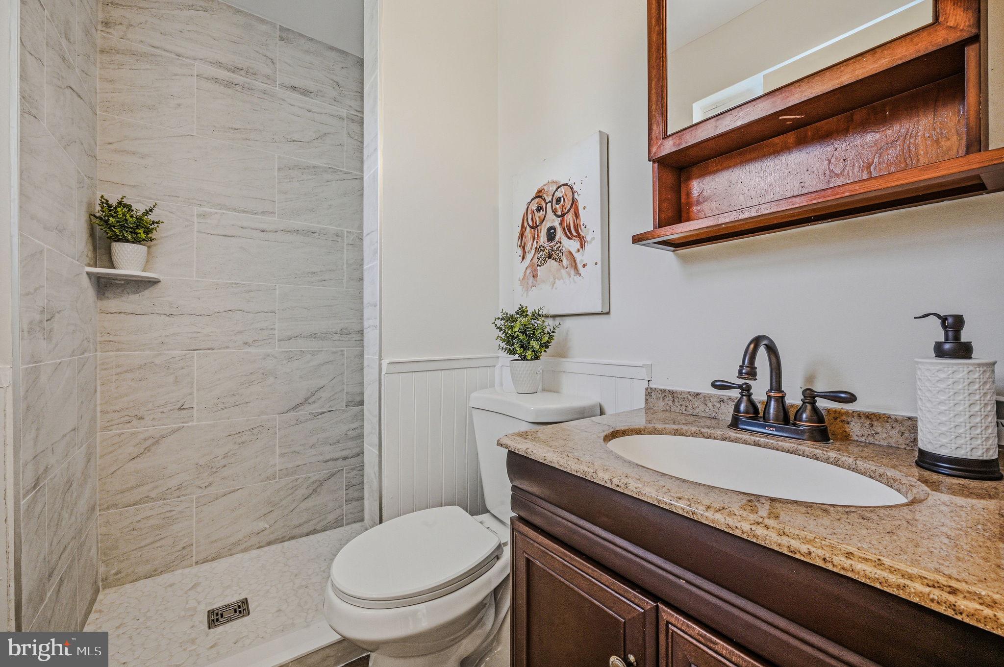 106 Fox Drive Newark, DE 19713 - Photo 36 of 37 a bathroom with a granite countertop toilet sink and mirror