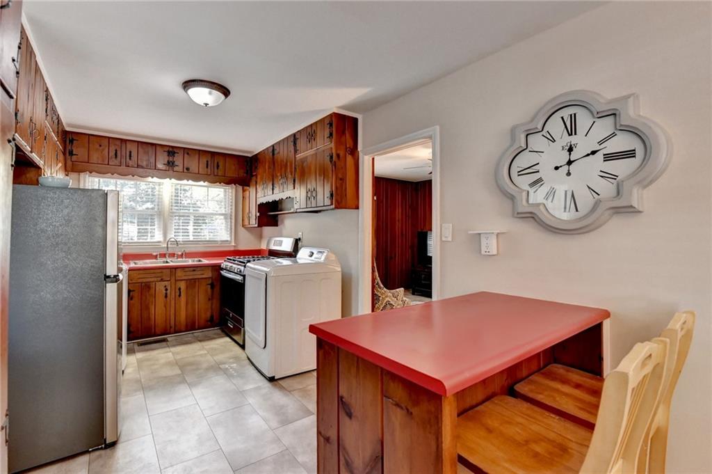 2805 Homeland Drive Atlanta, GA 30360 - Photo 49 of 74 a kitchen with a stove a refrigerator and a table