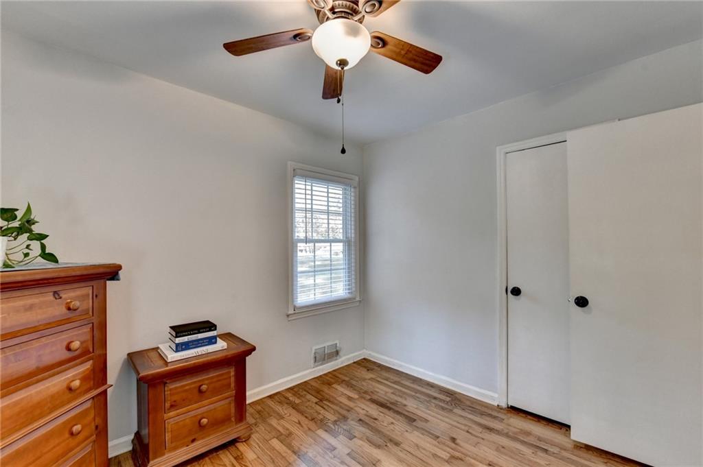 2805 Homeland Drive Atlanta, GA 30360 - Photo 61 of 74 a bedroom with a bed and wooden floor