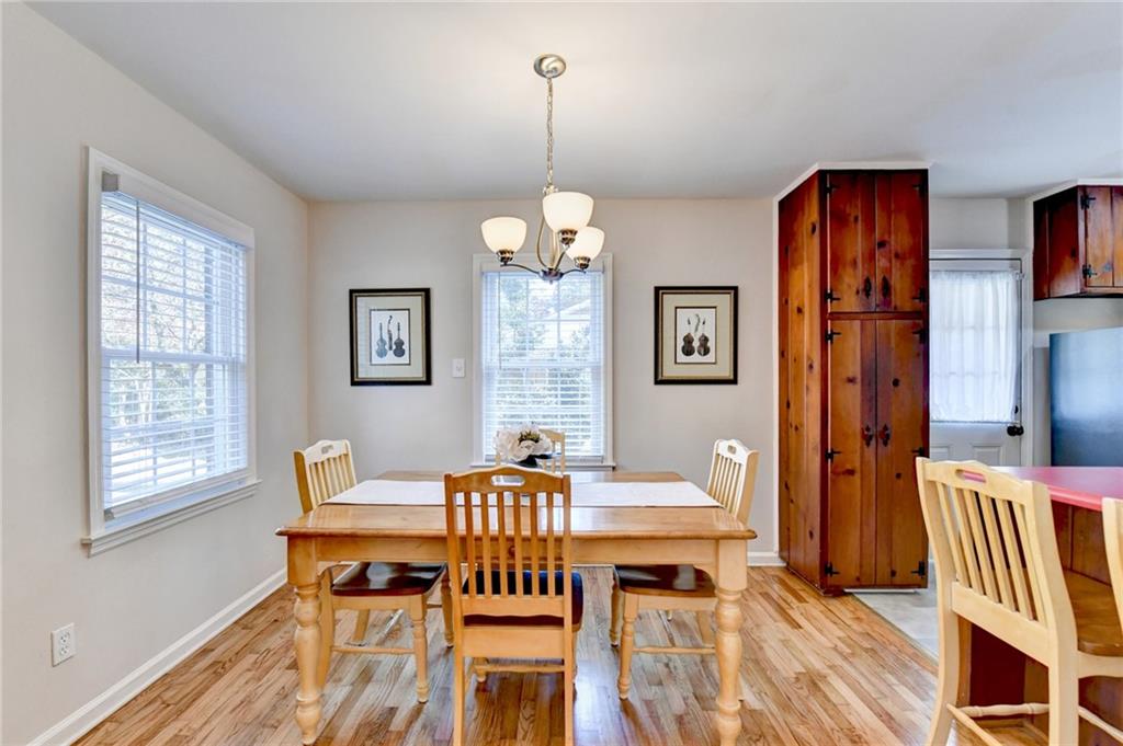 2805 Homeland Drive Atlanta, GA 30360 - Photo 7 of 74 a dining room with furniture a chandelier and wooden floor