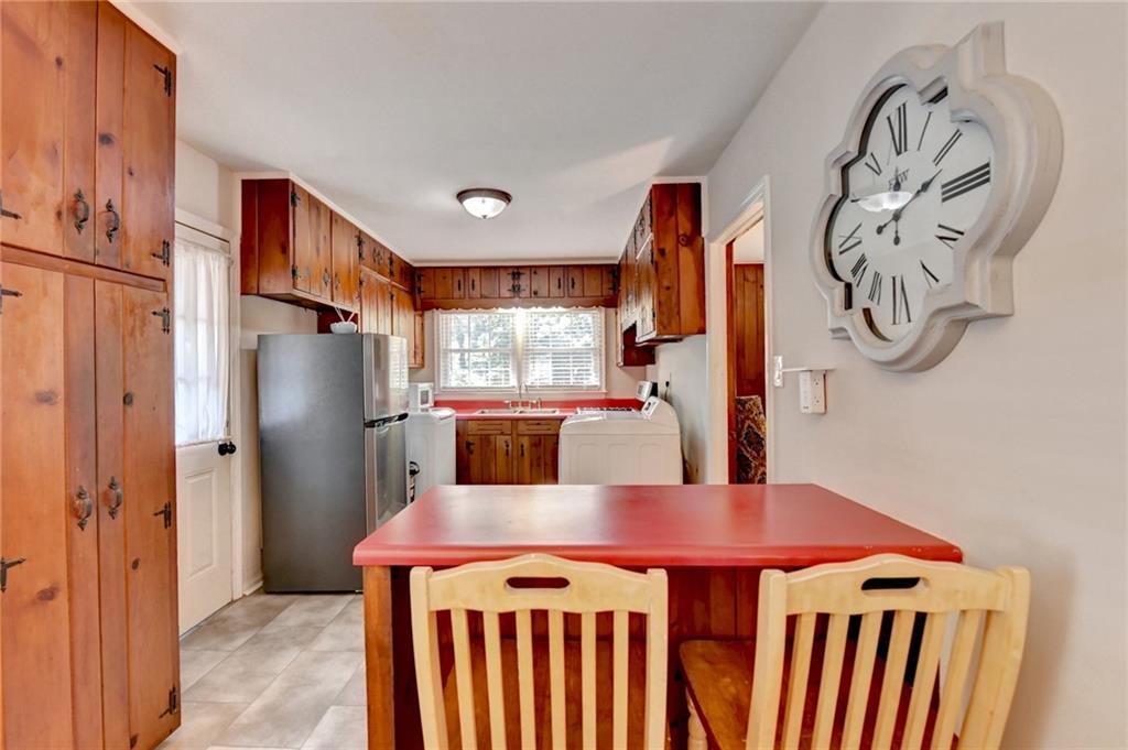 2805 Homeland Drive Atlanta, GA 30360 - Photo 8 of 74 a kitchen with stainless steel appliances granite countertop a refrigerator a stove a sink and a dining table with wooden floor