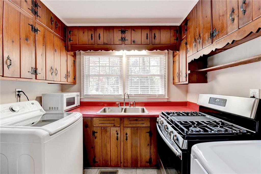 2805 Homeland Drive Atlanta, GA 30360 - Photo 9 of 74 a kitchen with a stove a sink and a cabinets