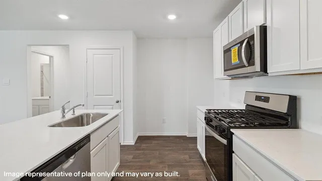 a kitchen that has a sink and a stove